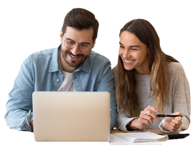 Couple smiling while looking at laptop.